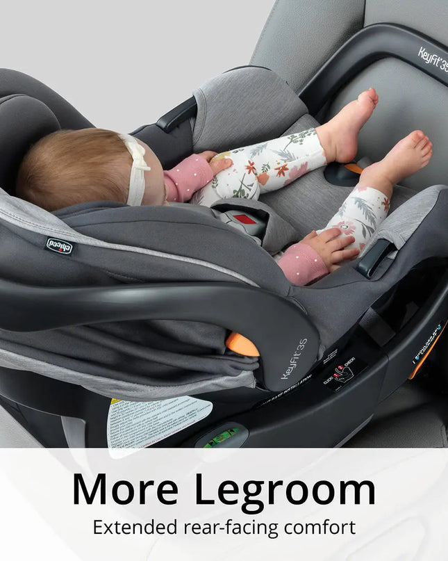 Baby in a car seat with extended legroom, brand 'Maxi-Cosi' visible