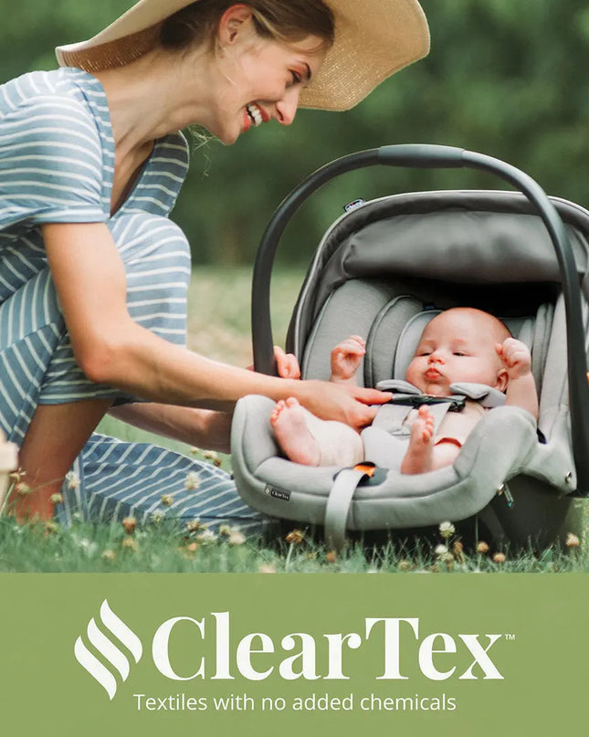 Woman adjusting a baby in a car seat outdoors with 'ClearTex' branding.