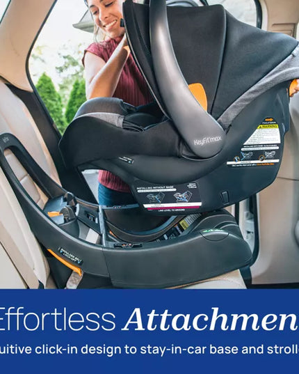 Baby car seat being installed in a vehicle with a woman assisting, emphasizing 'Effortless Attachment' feature.