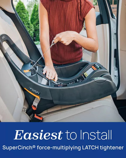 Person installing a car seat with SuperCinch technology in a vehicle.