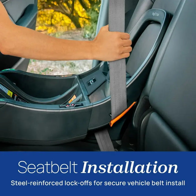 Person installing a seatbelt into a car seat with a blurred outdoor background