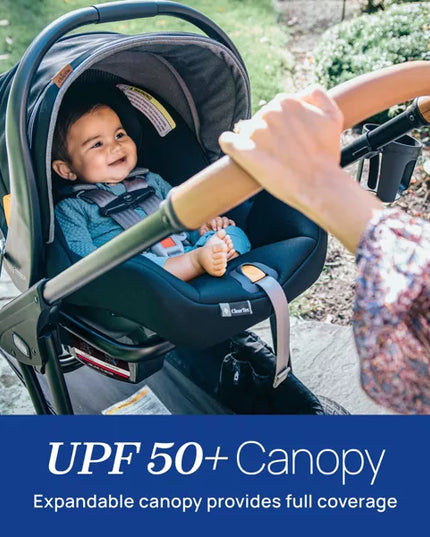 Child in a stroller with an expandable canopy, featuring UPF 50+ protection.
