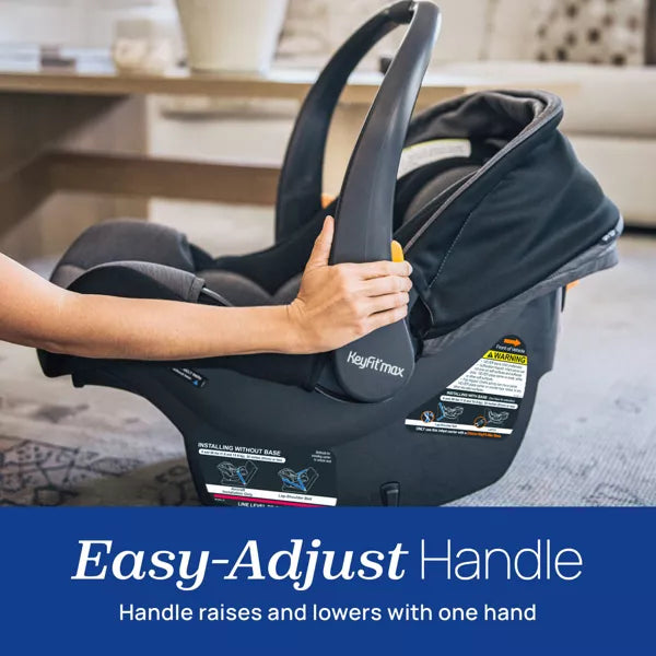 Baby car seat with an easy-adjust handle being held, set against a blurred indoor background.