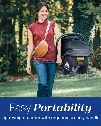 Woman carrying a baby carrier with a scenic background
