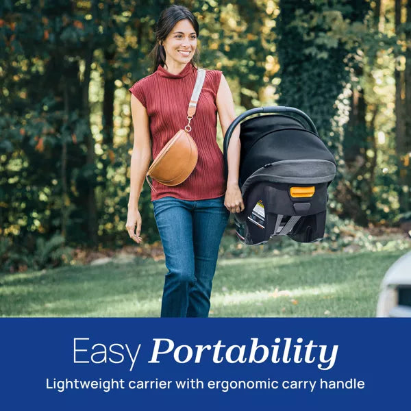 Woman carrying a baby carrier with a scenic background