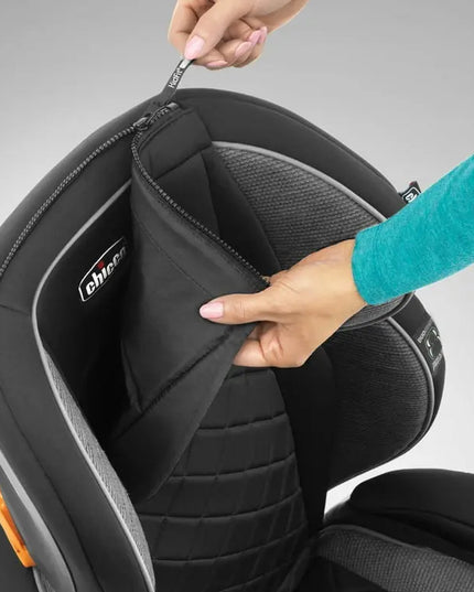 Close-up of a car seat with a hand opening the cover, showing the 'Evenflo' brand.