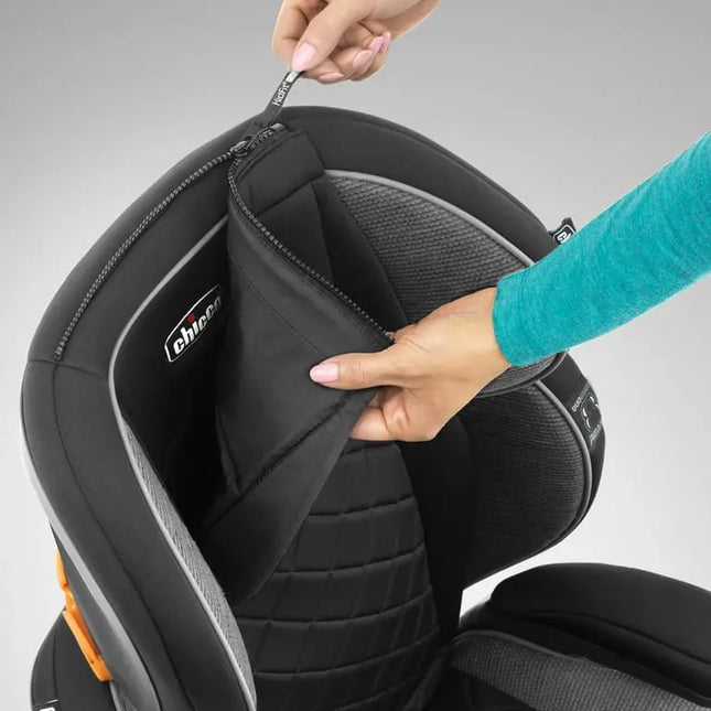 Close-up of a car seat with a hand opening the cover, showing the 'Evenflo' brand.