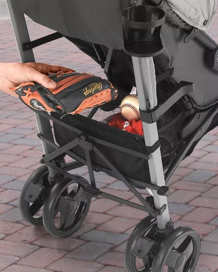 Person placing a tool box into a stroller on a paved walkway