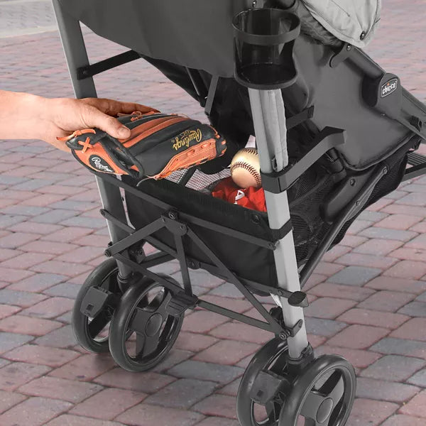 Person placing a tool box into a stroller on a paved walkway