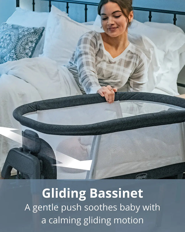 Woman with a gliding bassinet in a bedroom setting