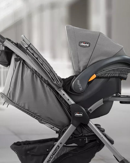 Gray and black baby car seat with 'Chicco' branding on a blurred indoor background