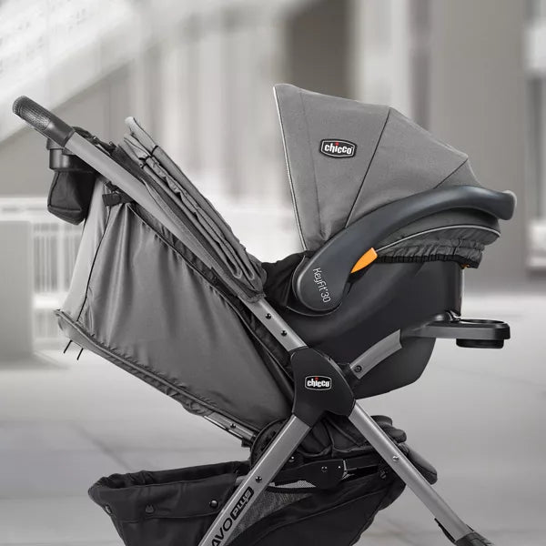 Gray and black baby car seat with 'Chicco' branding on a blurred indoor background