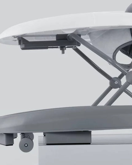 Close-up of a high chair with a white tray and gray seat on a light gray background