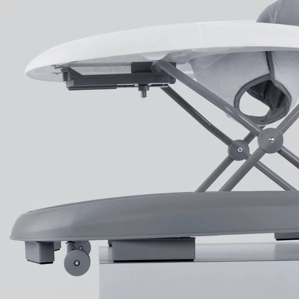 Close-up of a high chair with a white tray and gray seat on a light gray background
