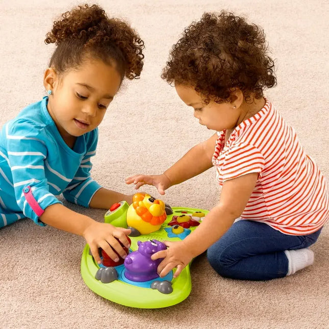 Two children playing with a colorful toy on a carpeted floor.