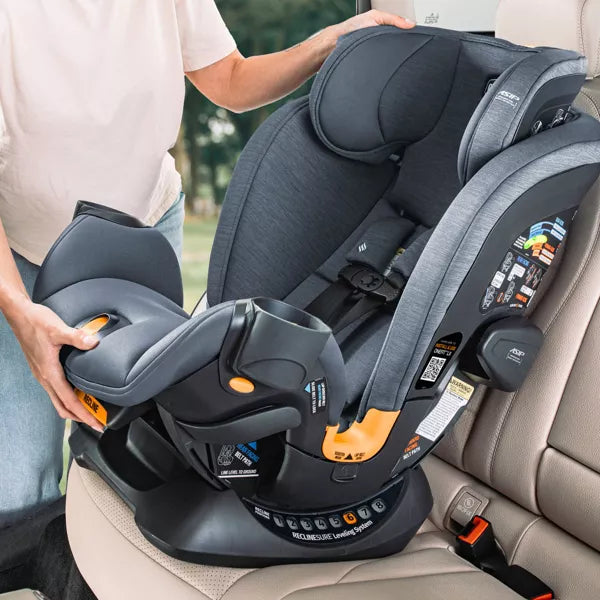 Person installing a gray car seat in a vehicle
