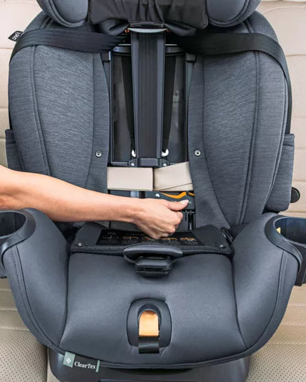Gray car seat with cup holders being adjusted by a person's hand on a beige car interior.