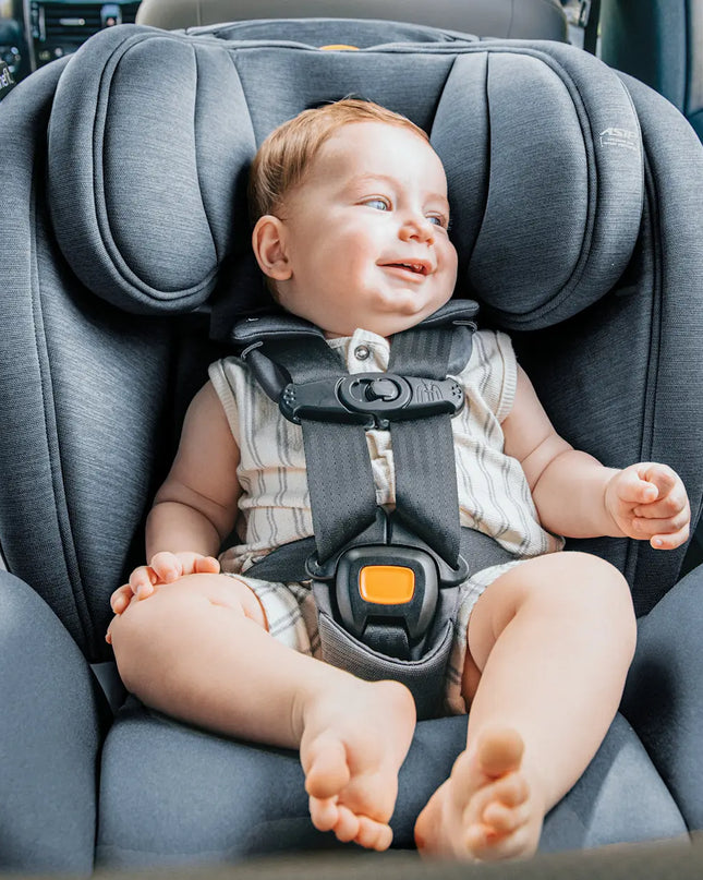 Baby sitting in a car seat inside a vehicle