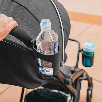 Bottle holder attached to a stroller with a water bottle inside, on a wooden floor.