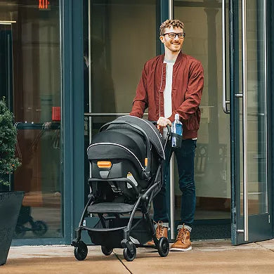 Man pushing a stroller out of a building