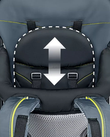 Close-up of a child safety seat with an arrow indicating the direction of the harness straps.