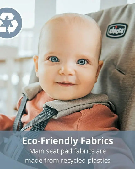 Baby in a high chair with eco-friendly fabrics label and Chicco logo.