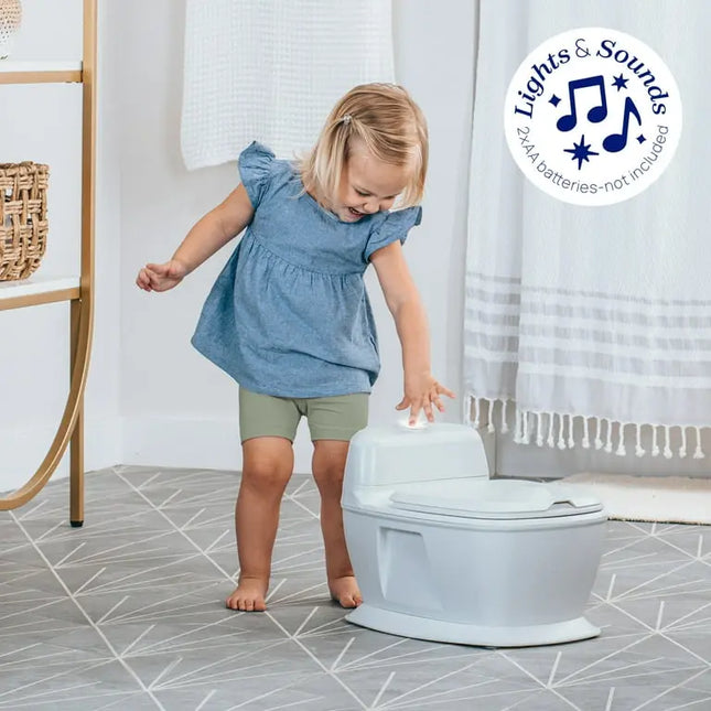Child interacting with a children's toilet trainer in a bathroom setting.