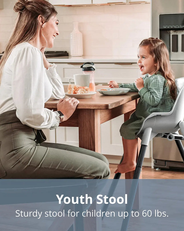Woman and child at a kitchen table with a high chair, emphasizing the youth stool's use.