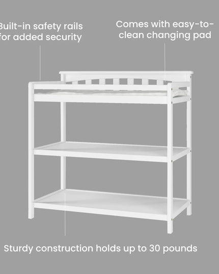 White changing table with safety rails and text on a gray background