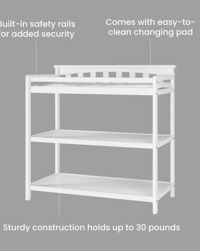 White changing table with safety rails and text on a gray background
