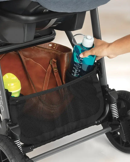 Stroller with a hand reaching into a mesh storage compartment to grab a blue bottle.