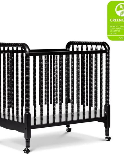 Black crib with a Greenguard Gold label on a white background