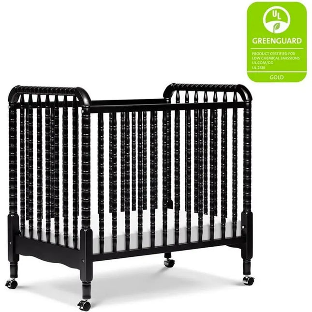 Black crib with a Greenguard Gold label on a white background