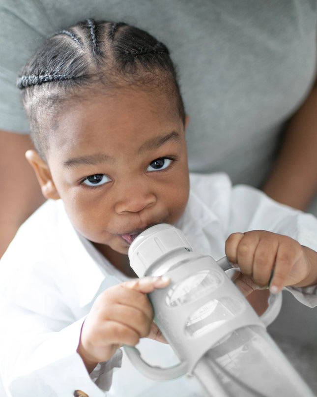 Child holding a white object with a blurred background