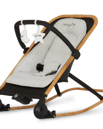 Baby bouncer with wooden frame and white cushion on a white background