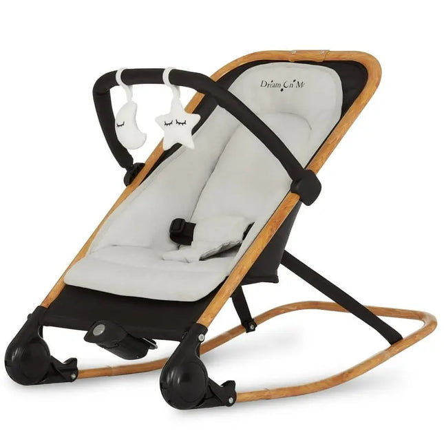Baby bouncer with wooden frame and white cushion on a white background