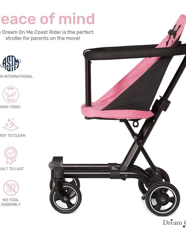 Pink and black stroller with safety certification logos on a white background