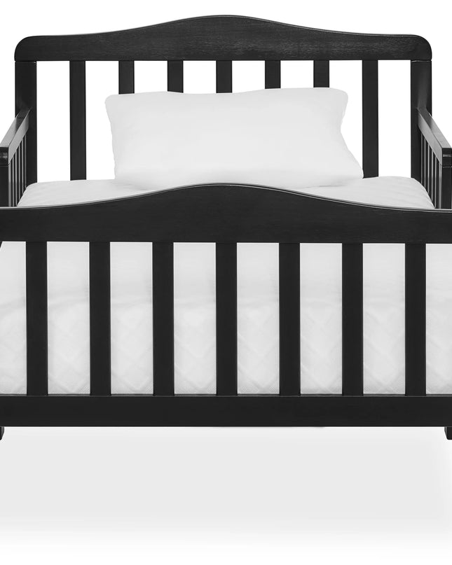 Black crib with white mattress and pillow on a white background