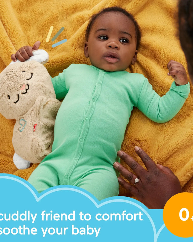 Baby in a green onesie holding a plush toy on a yellow blanket with text about comfort and soothing.