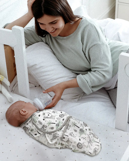Woman feeding a baby with a bottle in a crib