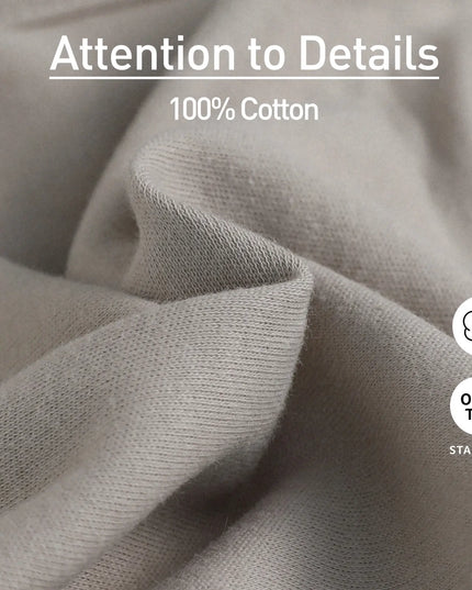 Close-up of gray fabric with 'Attention to Details' and '100% Cotton' text, featuring OEKO-TEX Standard 100 certification.
