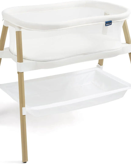 White bassinet with wooden legs on a white background