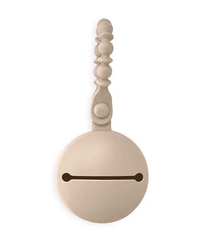 Decorative white bell with a wooden handle on a white background