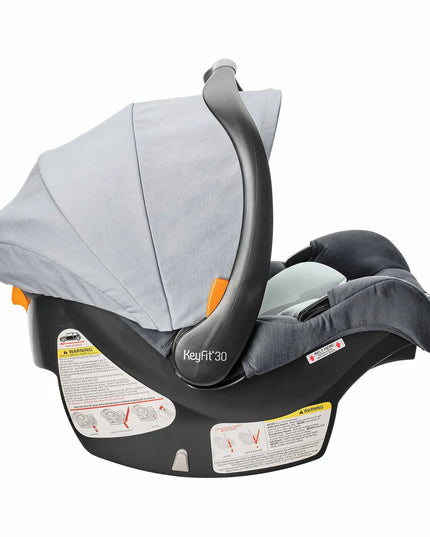 Baby car seat with gray canopy and black base on a white background