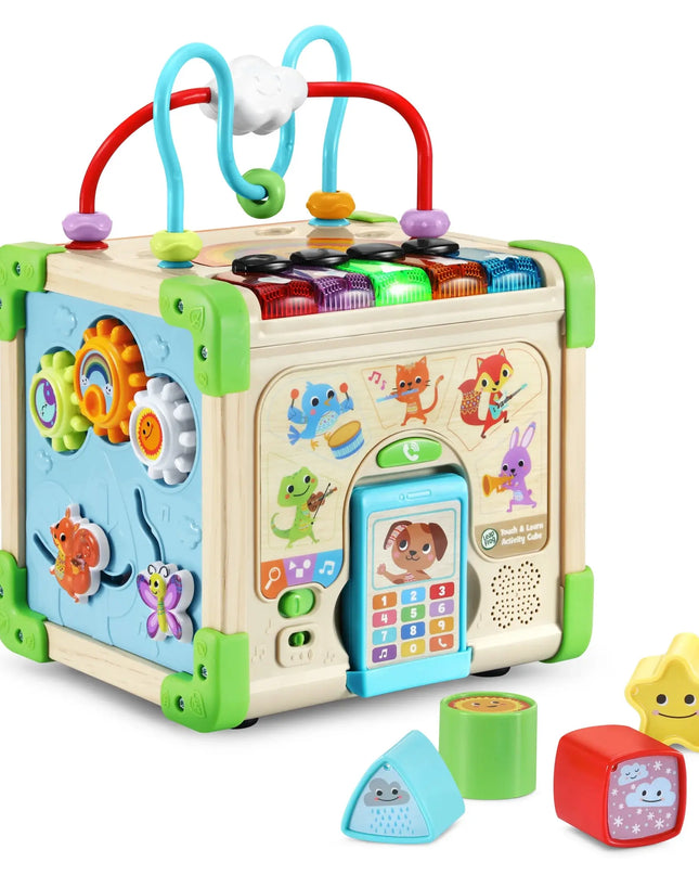 Colorful baby activity cube with various educational toys on a white background