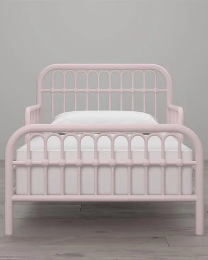 Pink metal bed frame with white mattress on a gray background