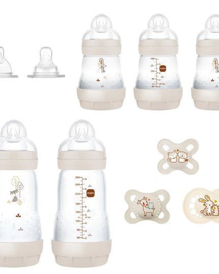 Set of baby bottles and pacifiers with measurement markings on a white background