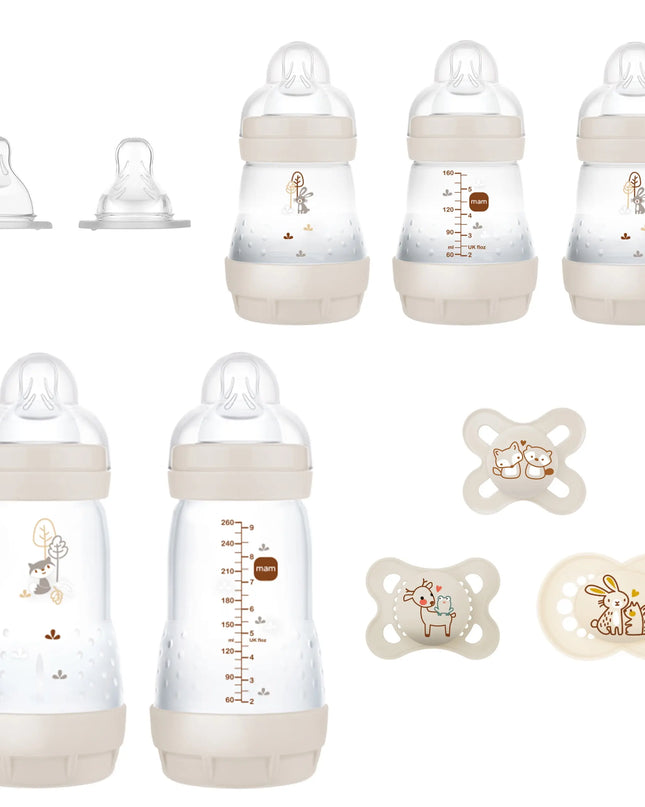 Set of baby bottles and pacifiers with measurement markings on a white background
