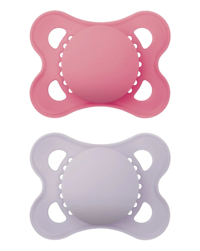Two pink and purple baby pacifiers on a white background