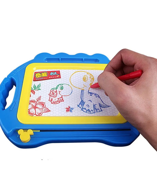 Hand drawing on a colorful magnetic drawing board with a red marker.